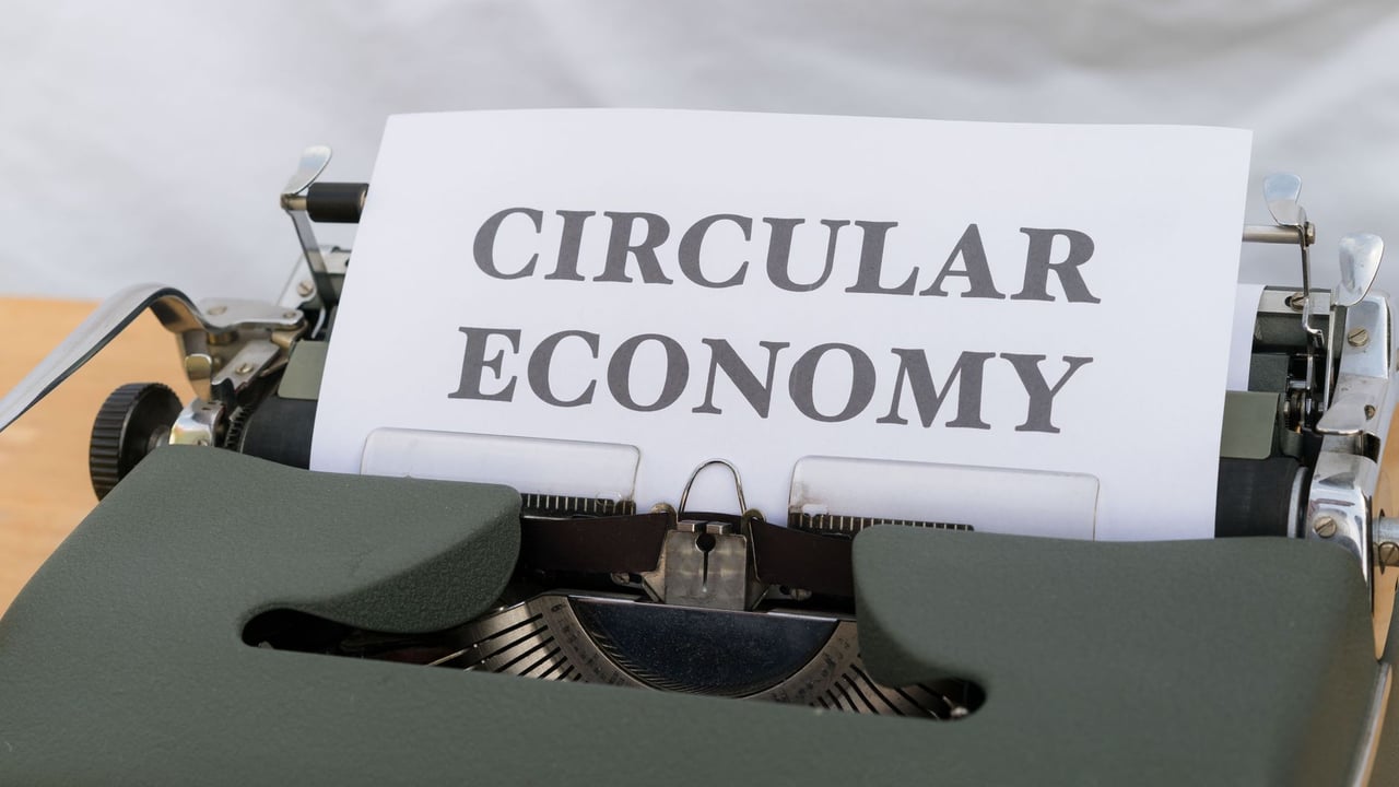 Vintage typewriter typing 'Circular Economy' document emphasizing sustainability.