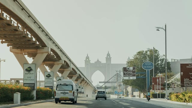 Explore Dubai's modern infrastructure near the iconic Atlantis Hotel and monorail track.