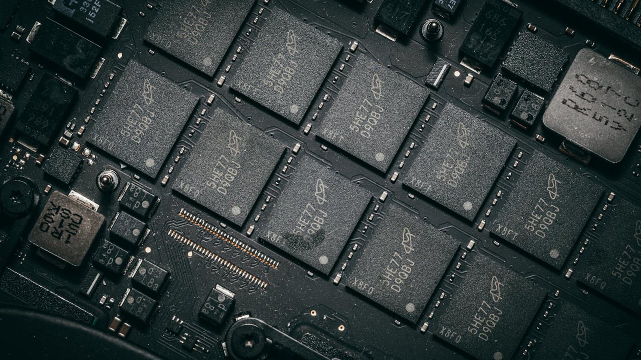 Detailed view of electronic circuit board components showcasing microchips and technology intricacies.