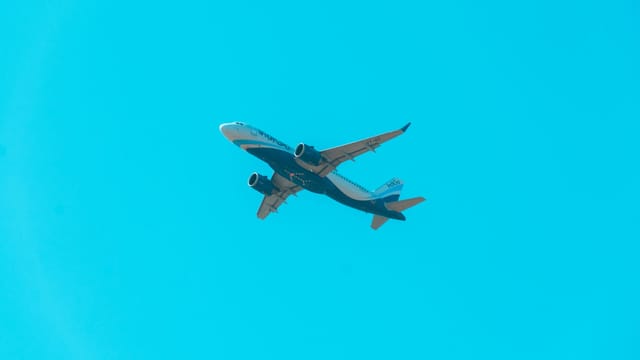 Commercial airplane soaring in a cloudless sky symbolizes travel and aviation.