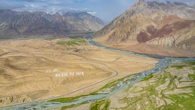Aerial view of a stunning mountain landscape with a winding river.