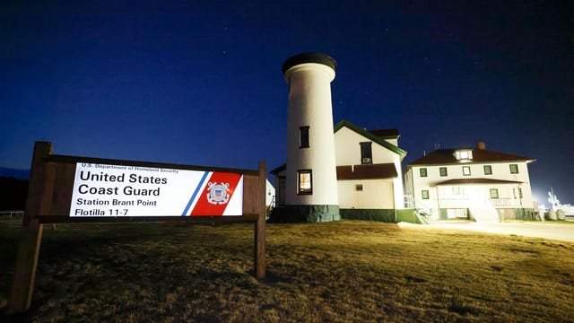 Night view of Brant Point Lighthouse and Coast Guard Station in Nantucket, MA.