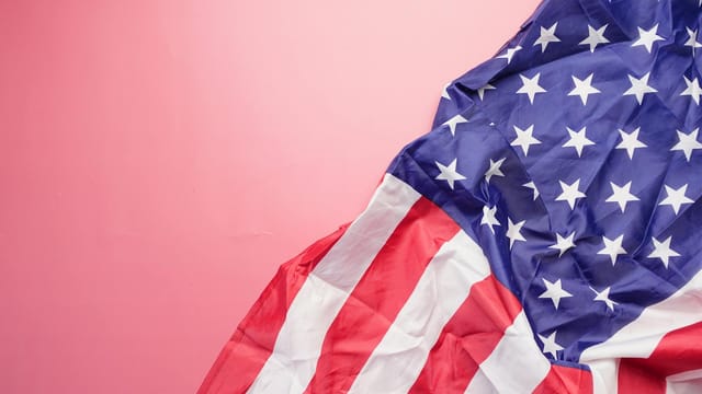 A vibrant image of the USA flag on a pink background, symbolizing patriotism and national pride.