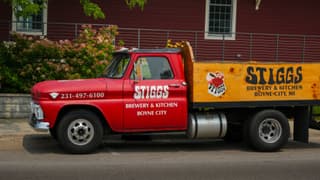 Red vintage truck promoting Stiggs Brewery & Kitchen in Boyne City, MI.