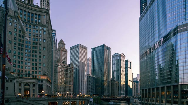 Chicago's skyline at dusk featuring modern skyscrapers and historic architecture along the river.