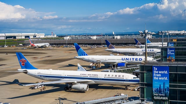 Busy runway at Narita International Airport featuring China Southern and United planes.