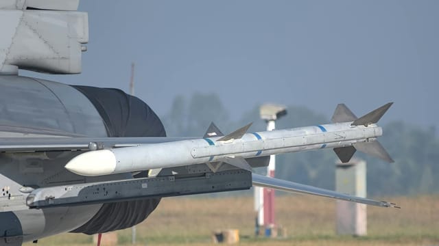 Close-up of a missile mounted on a military aircraft wing at an airshow in Bengaluru, India.
