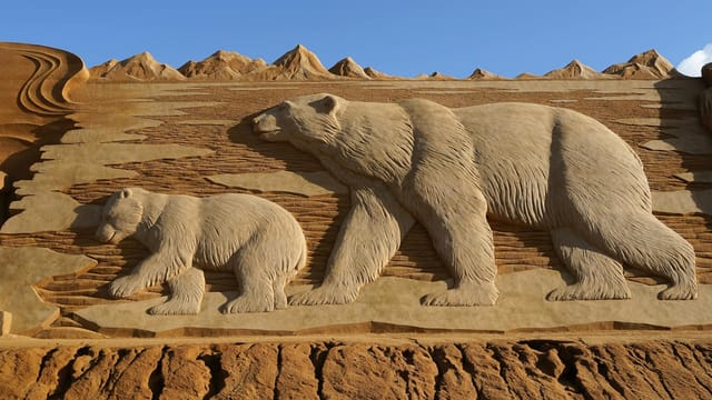 Impressive sand sculpture of bears at Søndervig in Denmark, perfect for art and travel themes.