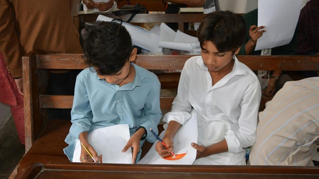 Boys drawing during Sunday school class at a church in Taxila, Pakistan.