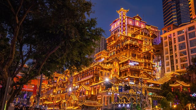 Stunning view of the illuminated Hongyadong complex in Chongqing at nighttime, showcasing vibrant urban architecture.
