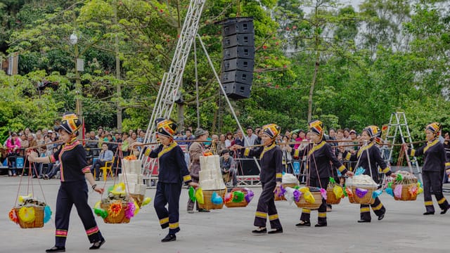 Local women in traditional attire participate in a vibrant festival parade in Guangxi, China.