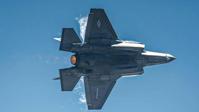 Top view of an F-35 Lightning fighter jet showcasing advanced stealth technology and engines.