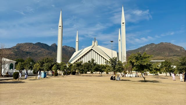 A magnificent view of Faisal Mosque with Margalla Hills in Islamabad, Pakistan.
