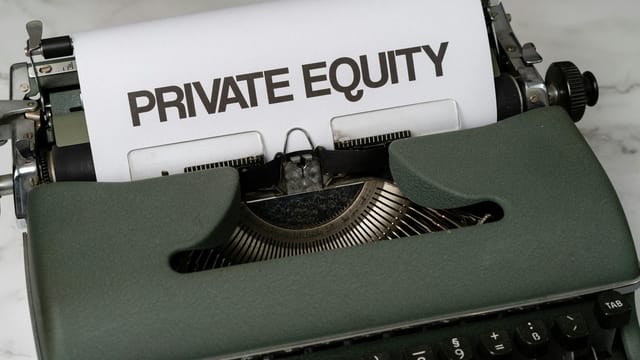 Close-up of vintage typewriter with 'PRIVATE EQUITY' on paper, business concept.