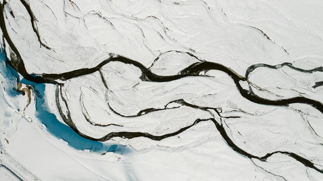 Majestic aerial view of a meandering snow-covered river in winter, Russia.