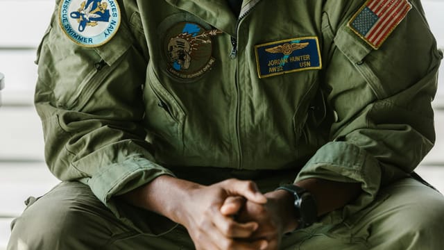 Detail of a US military uniform showcasing patches indicating honor and bravery.