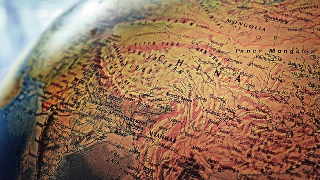Explore the intricate details of China and neighboring regions in this vintage-style globe photo.