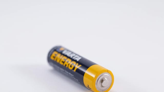 Detailed close-up of a single Varta Energy AA battery on a white background.
