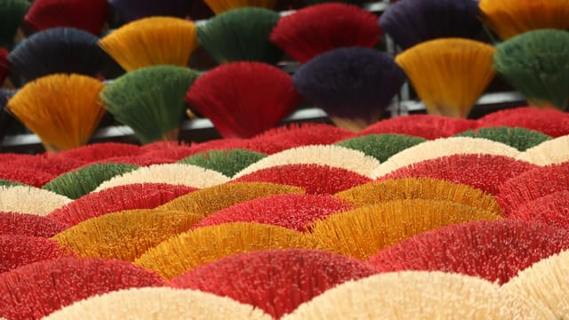 Vibrant bundles of incense sticks arranged in a vivid, eye-catching display.