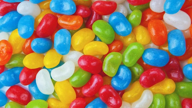 Vibrant and colorful close-up of assorted jelly beans creating a playful and sweet background.