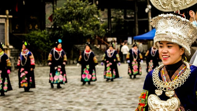 Miao women in traditional attire celebrate a cultural festival in Guizhou, China.
