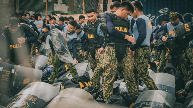 Philippine police officers in tactical gear prepare for a training exercise in Metro Manila.