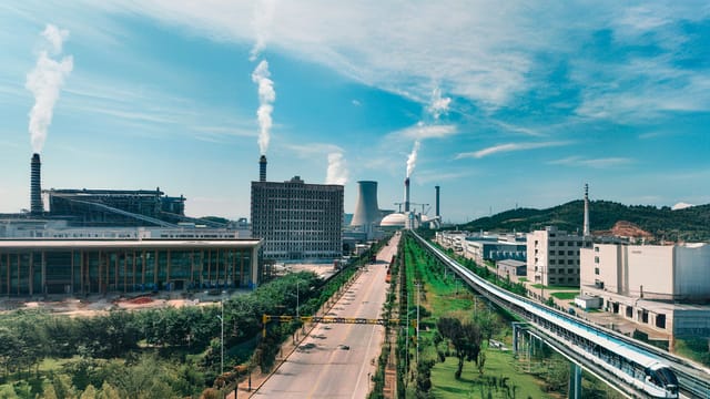 Aerial view of Jiujiang industrial area with factories and smoke stacks.