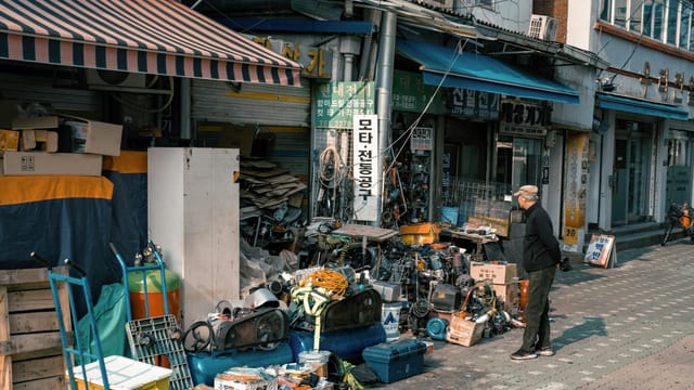 Outdoor shop in Seoul bustling with assorted goods and vibrant street activity.
