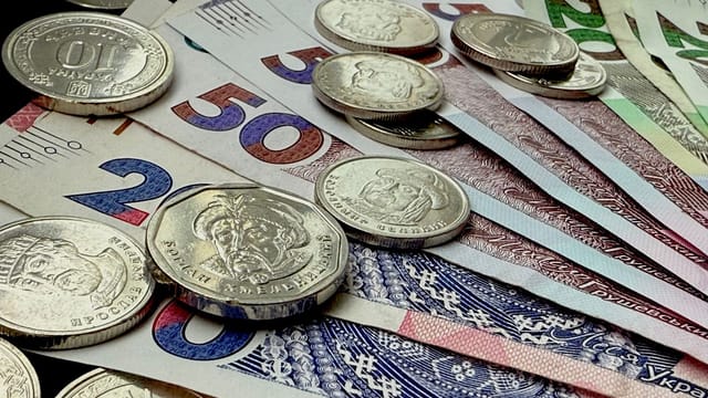 Close-up of various coins and banknotes from different countries, showcasing diversity in currency.