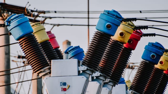 Colorful high voltage insulators in an electric substation highlighting power infrastructure.