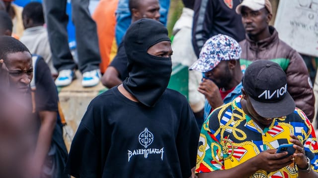 A colorful and peaceful street protest with a diverse group of people advocating for change in Nigeria.
