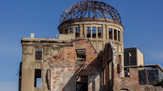 The Hiroshima Peace Memorial in Japan, showcasing historical architecture against a clear blue sky.
