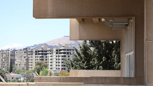 Elevated architectural view showcasing Damascus cityscape with buildings and greenery. Captures unique urban perspective.