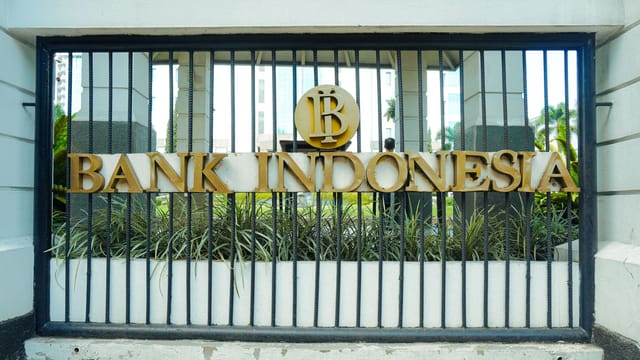 The entrance gate of Bank Indonesia in Bandung, showcasing the iconic logo and architecture.
