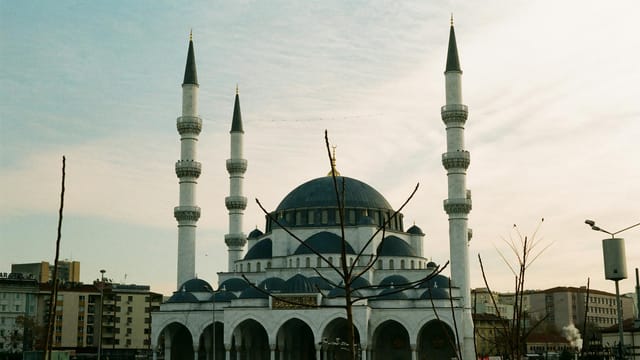 Impressive Melike Hatun Mosque with minarets, capturing Ankara's skyline at dusk.