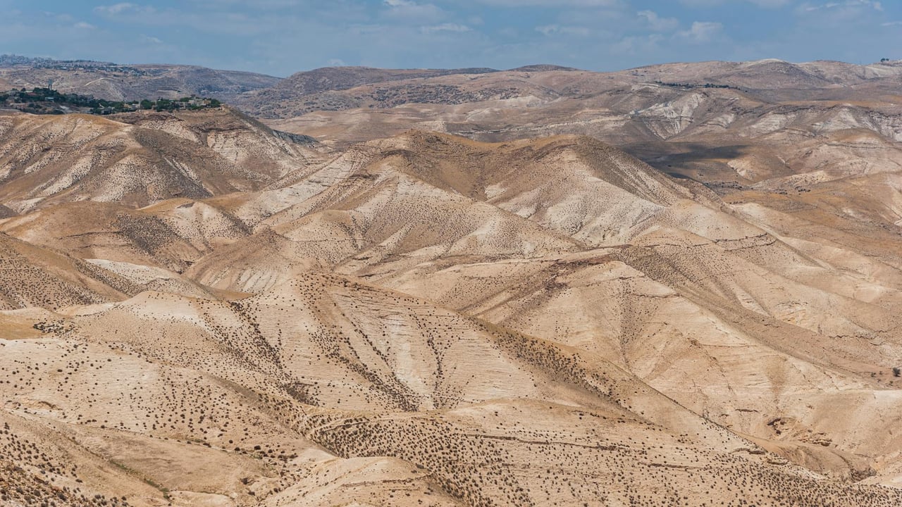 Scenic view of arid desert hills under a clear blue sky in Israel.