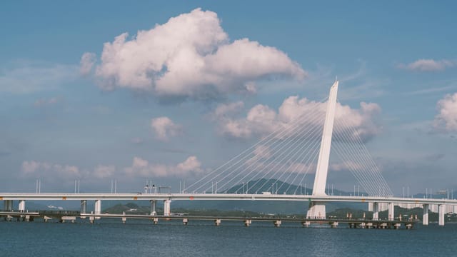 Stunning view of Shenzhen Bay Bridge under a clear blue sky, showcasing modern architectural design.