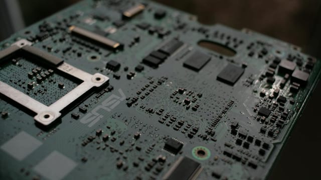 Detailed view of a computer motherboard showcasing intricate electronic components.