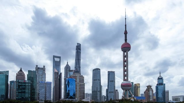 Dramatic skyline of Shanghai featuring iconic skyscrapers and the Oriental Pearl Tower.
