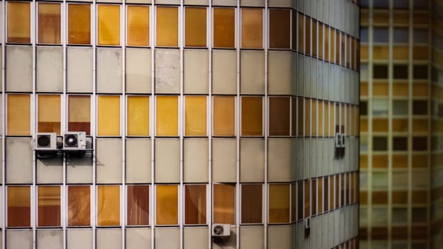 Contemporary building facade with air conditioning units, showcasing architectural design in Lisbon.