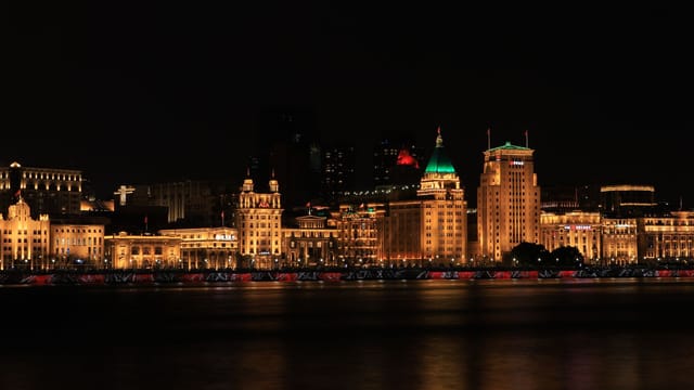 Stunning night view of Shanghai's Bund, showcasing illuminated historic buildings along the waterfront.