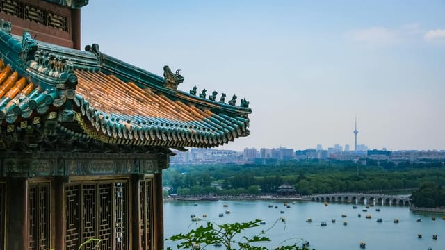 Elegant Chinese architecture with city skyline and lake view in Beijing, China.