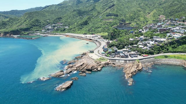 Aerial view of Taiwan's lush coastline with vibrant blue oceans and picturesque landscape.