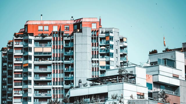 Modern residential buildings in Bern, featuring glass windows and vibrant design.