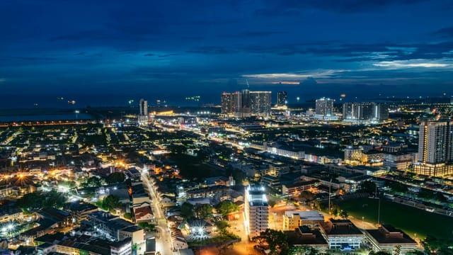 A breathtaking aerial night view of Malacca's illuminated cityscape in Malaysia.