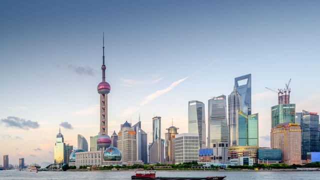Stunning view of Shanghai's skyline at sunset with iconic skyscrapers and waterfront.