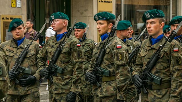 Polish soldiers in camouflage uniforms during a military parade in Wrocław, Poland.