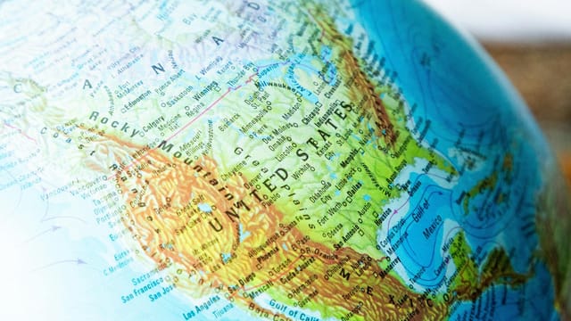 A detailed close-up of a globe featuring North America, emphasizing political boundaries and geographical features.