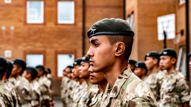 Gurkha soldiers standing in formation in Catterick, England, dressed in uniforms.