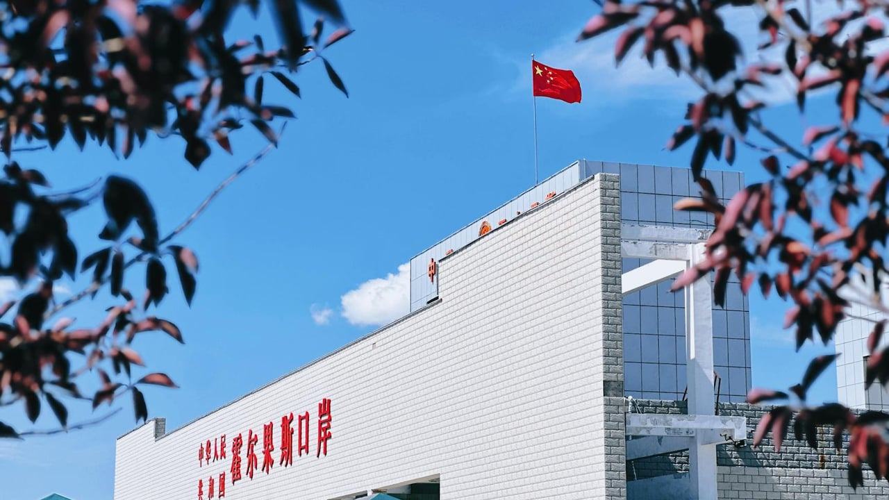 A view of Korghos Port featuring the Chinese flag on a sunny day.